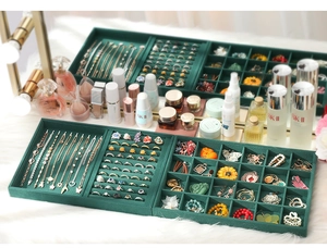 Detailed view of dark green velvet jewelry trays for rings, necklaces and earrings