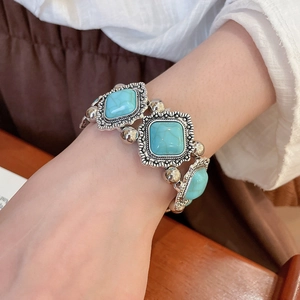 Close-up of bohemian turquoise geometric stones set in carved vintage silver metal