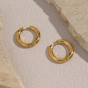 Macro view of high-polished 18K gold plated stainless steel chunky hoop earrings