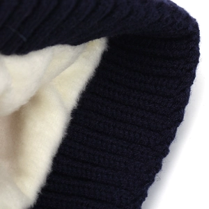 Navy blue winter knit hat with warm white fleece lining and thick ribbed texture