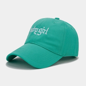 Detail of baby girl embroidery on a mint green cotton baseball cap with gothic font