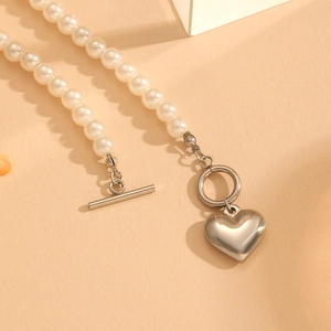 Polished stainless steel pearl necklace with a silver heart pendant and OT toggle clasp