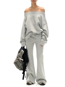 Detail of grey off-shoulder sweatshirt and matching wide-leg trousers on a model