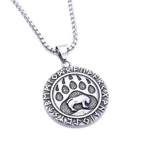 Detail of a vintage Viking grizzly bear paw pendant with runes on a box chain