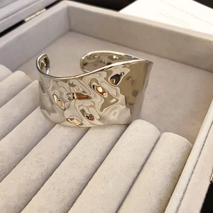 Detail of silver hammered texture cuff bracelet with minimalist geometric design
