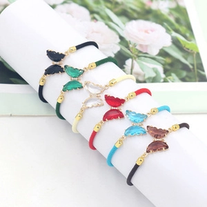 Detail of colorful butterfly resin hair ties and bracelets with elastic cord set