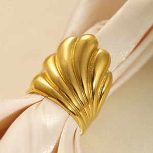 Exaggerated 18k gold plated stainless steel heart ring on a beige silk fabric background