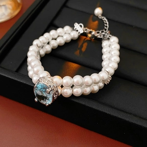 Bracelet double rangée de perles avec pierre bleue et fermoir en argent