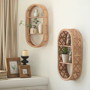 Oval woven bamboo wall shelf in natural wood tone for minimalist home decor