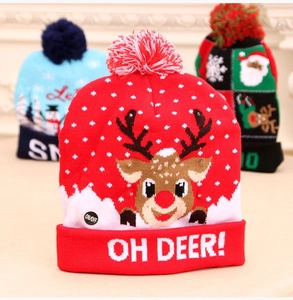Close-up of a festive LED knitted Christmas hat featuring a red reindeer design and LED lights