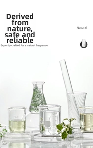 Laboratory setup with glass beakers and green plants for natural essential oil extraction