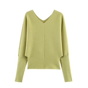 Detail of V-neck knitted sweater featuring batwing sleeves and long ribbed cuffs in green