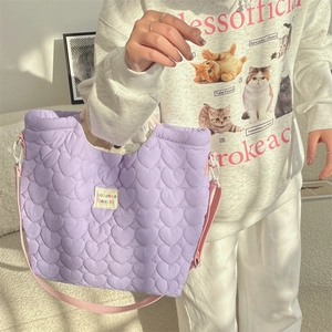 Détail du sac bandoulière violet matelassé cœur avec sangle réglable et étiquette