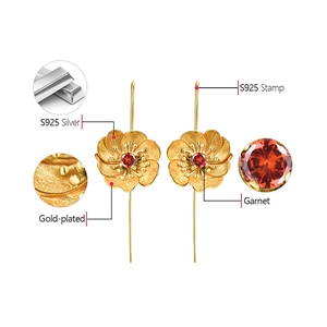 Detail view of S925 silver gold-plated flower earrings with inlaid natural garnet stones