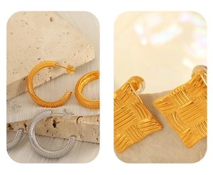Detail of C-shaped crescent earrings and square studs with unique dotted metal texture