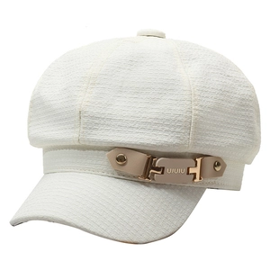 White tweed newsboy cap with tan leather strap and gold buckle in a stylish British style