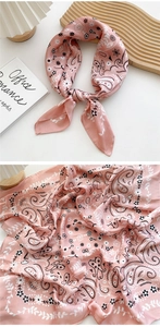 Close-up of pink paisley silk scarf showing smooth texture and floral pattern details