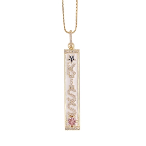 Detailed view of 18K gold plated bar pendant with micro-pave crystals and zircon accents