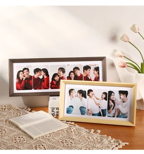 Macro detail of solid wood multi-pane photo frames on a lace cloth with natural warm lighting