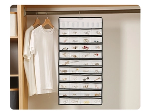 Detail of hanging jewelry organizer with transparent PVC pockets in a wooden closet