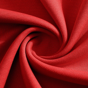 Close-up of red polo shirt mesh fabric showing fine knitted texture and soft breathability