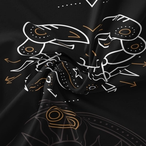 Detail of bohemian tapestry fabric with gold and white celestial patterns on black