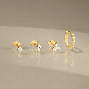 Detailed macro view of S925 sterling silver stamp on gold geometric zircon earring set