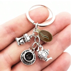 Silver vintage coffee keychain with mixer, cup, pot and brown bean charms on hand