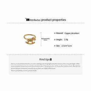 Detail view of a golden rocking horse ring with zirconium inlay and product specifications