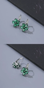 Macro shot of silver leverback earrings featuring emerald green crystal flower petals