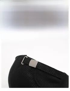 Detail of adjustable metal buckle and corduroy fabric on a black winter baseball cap