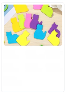 Detailed view of colorful cat-shaped sticky notes on a wooden table for office marking