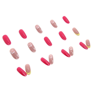 Summer press-on nails set with pink floral designs and yellow French tips on white background