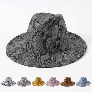 Detail view of various snake skin pattern wide brim fedora hats in multiple colors