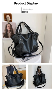 Detail view of large black canvas tote bag showing metal rivets and adjustable shoulder strap