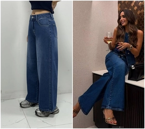 Detail of high waisted wide leg denim jeans in classic indigo wash for women