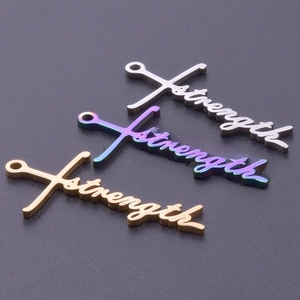 Detailed macro view of 18k gold and silver stainless steel Strength cross pendants