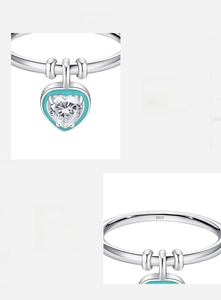Macro detail of S925 silver ring with mint green enamel and heart zircon pendant