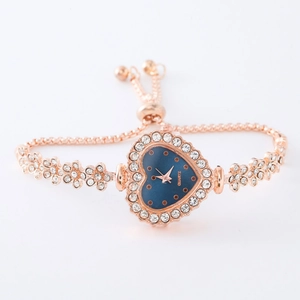 Detail of rose gold flower bracelet watch with blue heart dial and adjustable slider