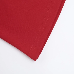 Macro view of red fishtail dress fabric texture and double-needle stitching detail
