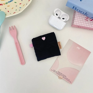 Close-up of black heart quilted soft shell earphone pouch with pink heart button detail