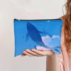 Détail d'une trousse à maquillage en toile avec imprimé baleine bleue et ciel étoilé
