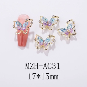 Detailed view of 17x15mm golden butterfly nail charm with purple gradient and pearls