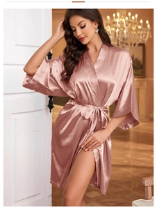Detailed view of rose gold satin robe with silk-like texture and elegant belted waist
