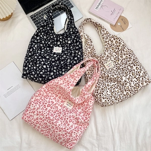 Detailed flat lay of heart and leopard print tote bags with casual lifestyle props