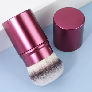 Portable retractable makeup brush with magenta aluminum handle and soft synthetic bristles