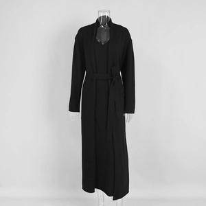 Detail of black knitted long sleeve cardigan and matching maxi dress set with waist belt