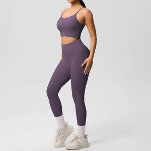 Close-up of purple yoga set with high-waist leggings and thin strap sports bra for fitness