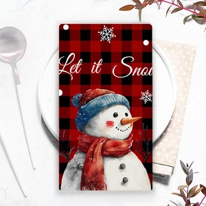 Christmas snowman kitchen towel with red plaid print on white plate for table decor