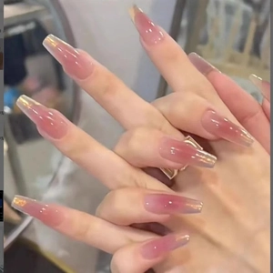 Nahaufnahme von glänzenden rosa Ombre-Kunstnägeln in langer Sargform mit Glitzereffekt